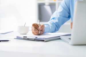 Close-up-of-male-hand-making-notes-in-office-1920x1281